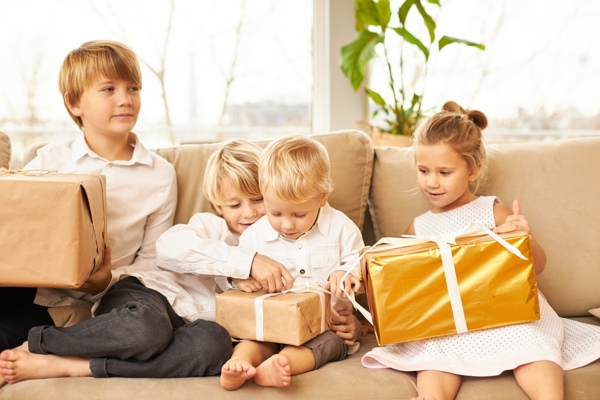 Niños abriendo regalos en Navidad